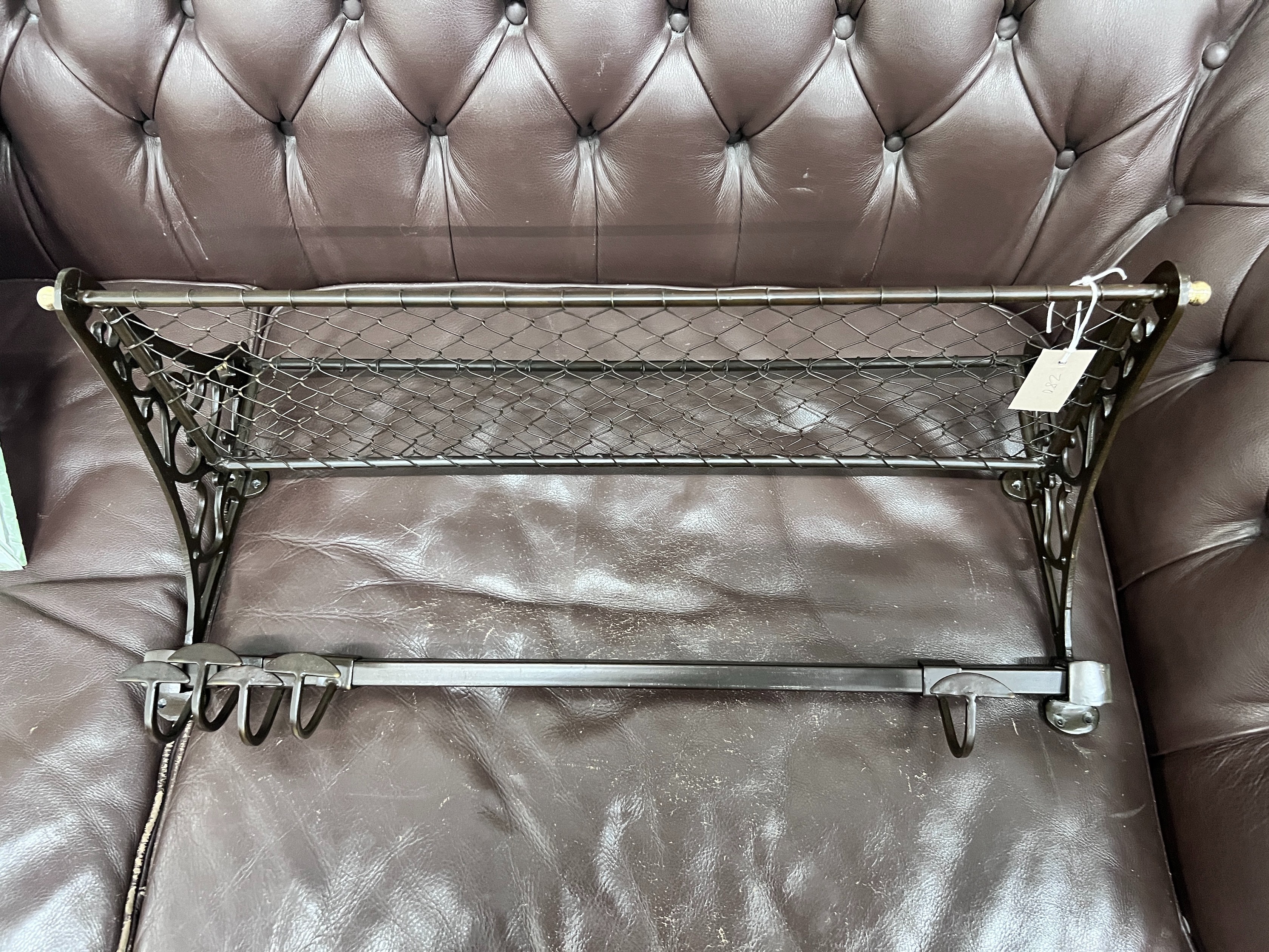 A bronzed metal wall hanging coat rack, width 75cm *Please note the sale commences at 9am.